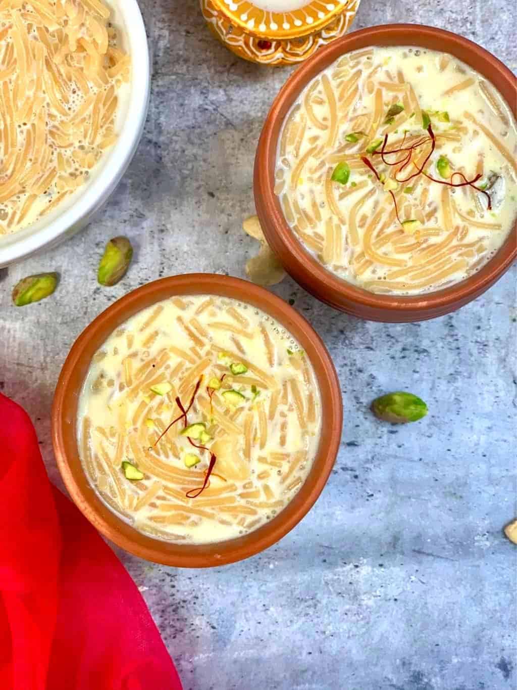 vermicelli kheer served in two mud pots garnished with nuts and saffron