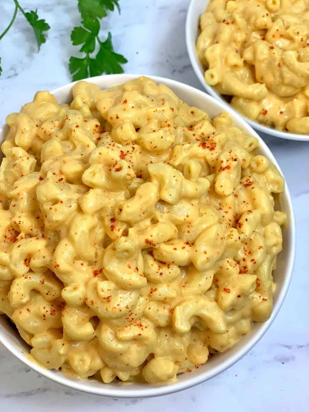 instant pot vegan mac and cheese served in a bowl with a dash of paprika on top