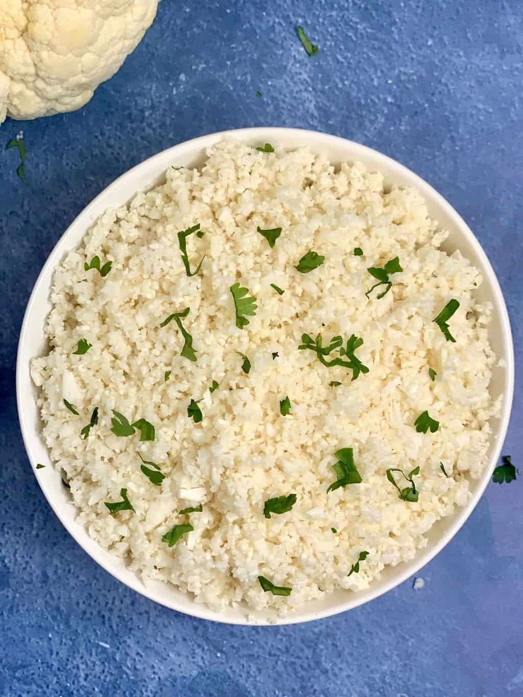 cauliflower rice served in a bowl garnished with cilantro