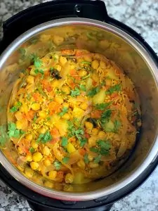 chana biryani in instant pot insert garnished with cilantro