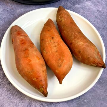 instant pot boiled sweet potatoes on a white plate