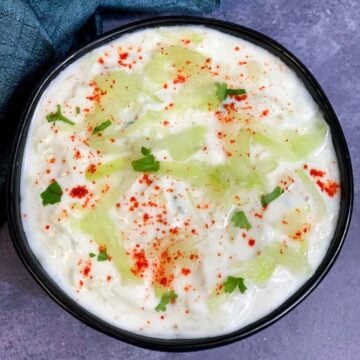 lauki raita served in a bowl garnished with cilantro