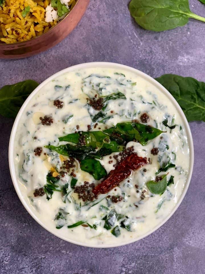 palak raita served in a bowl with tempering on the top