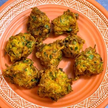 Crispy Zucchini Pakoda served on a brown plate