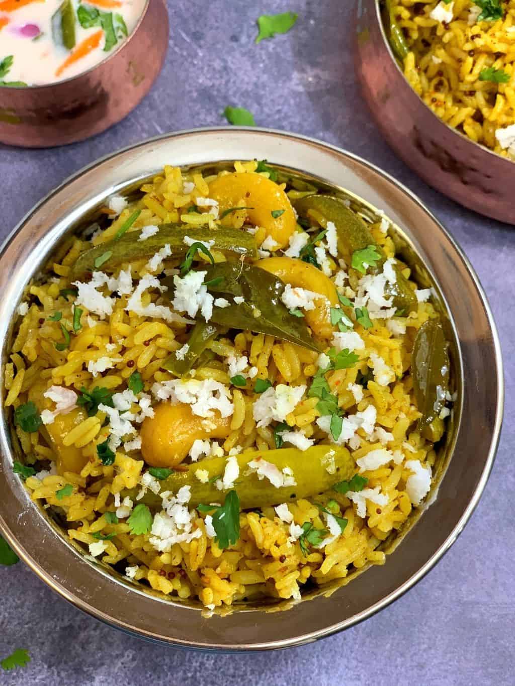 instant pot tindora bhaat served in a vessel garnished with fresh coconut and cilantro