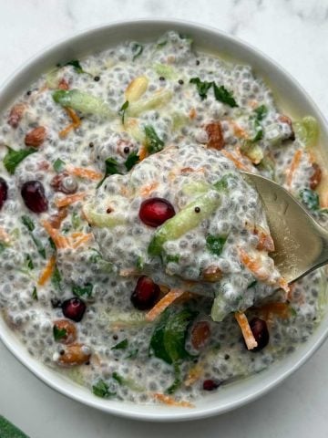 Savory chia seeds curd rice served in a bowl with a spoonful of creamy chia curd.