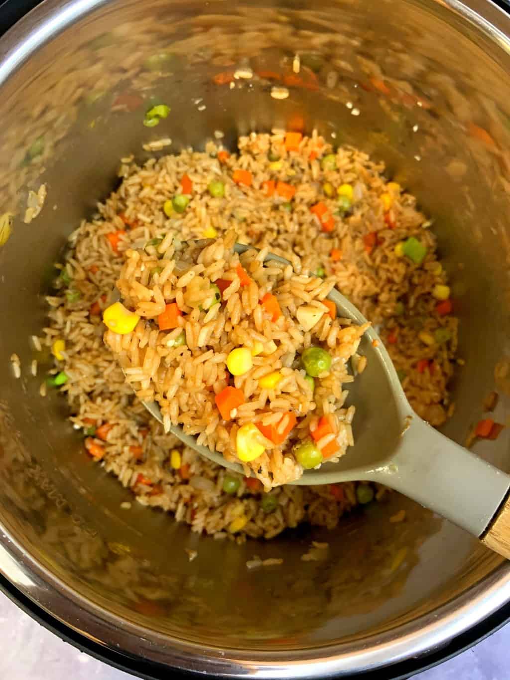  Instant Pot vegetable fried rice in a silicon spoon
