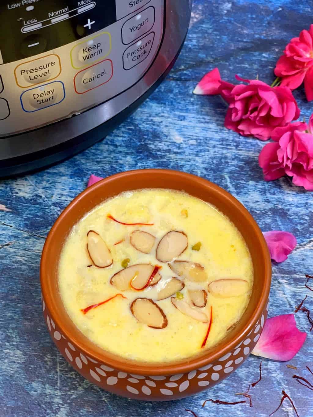 lauki kheer served in a brown bowl with rose petals in the side and instant pot