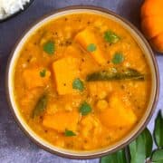 Pumpkin Sambar made of lentils and pumpkin served in a bowl with cooked rice on side