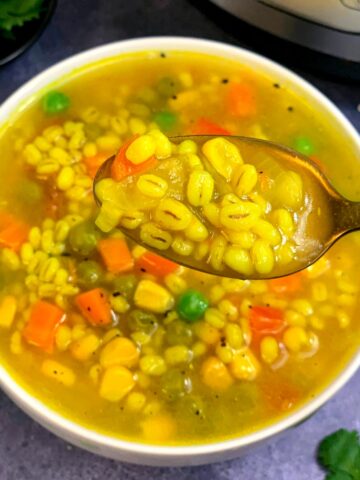 Vegetable and Pearl Barley Soup served in a white bowl
