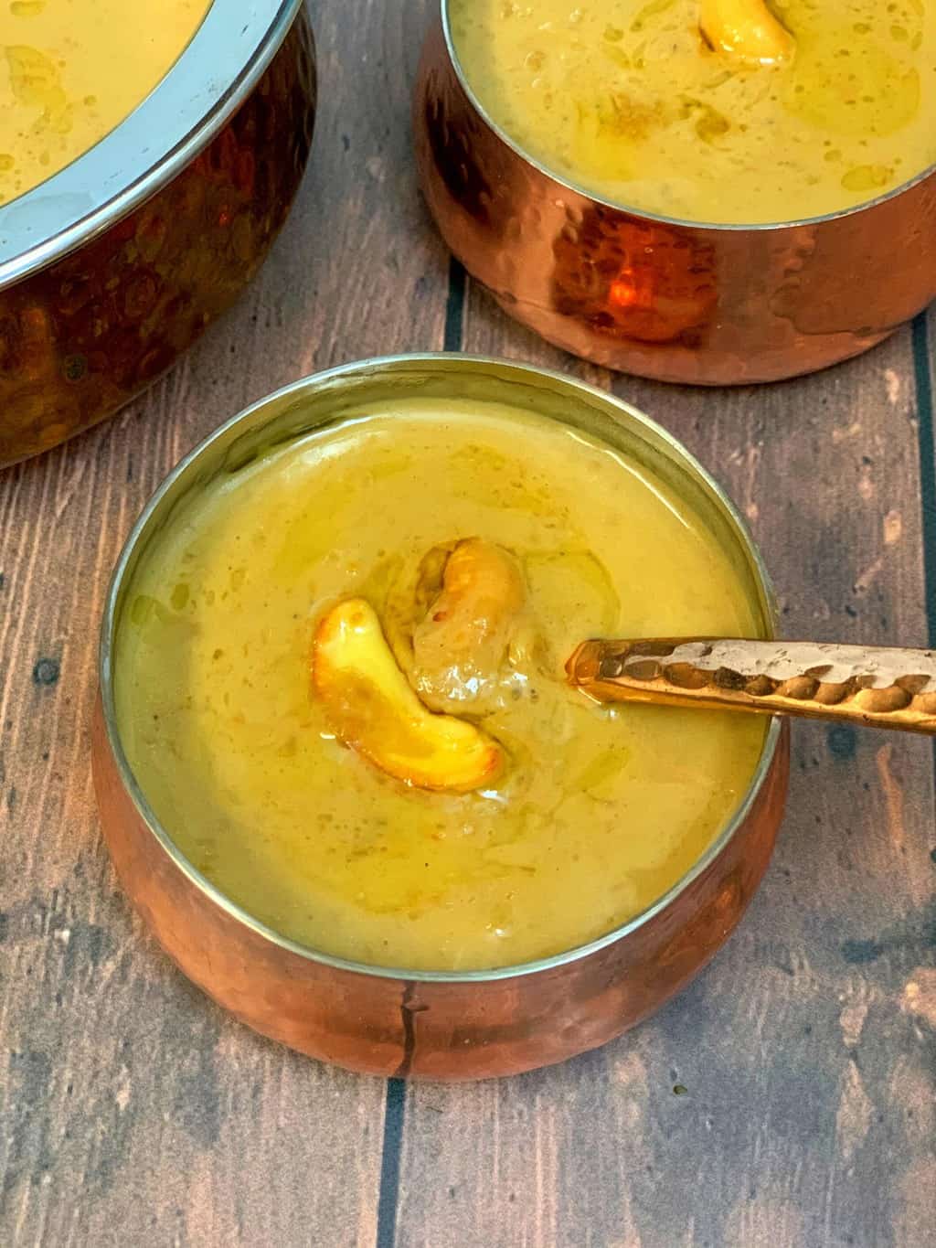 instant pot chana dal payasam served in steel bowls garnished with roasted cashews