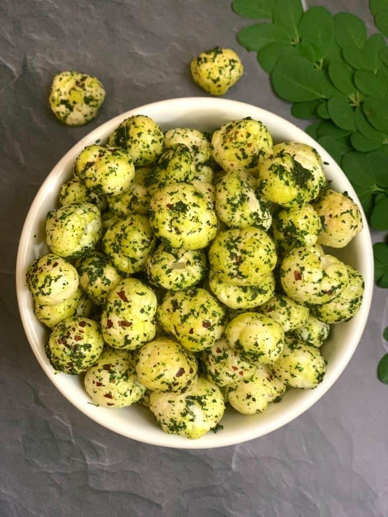 moringa makhana served in a bowl with moringa leaves on side