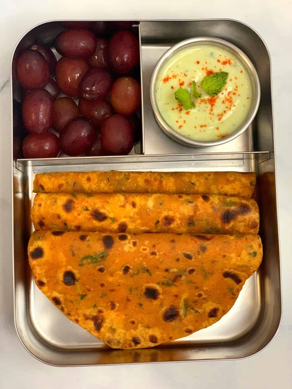 butternut squash paratha with mint raita and grapes in bento steel lunch box