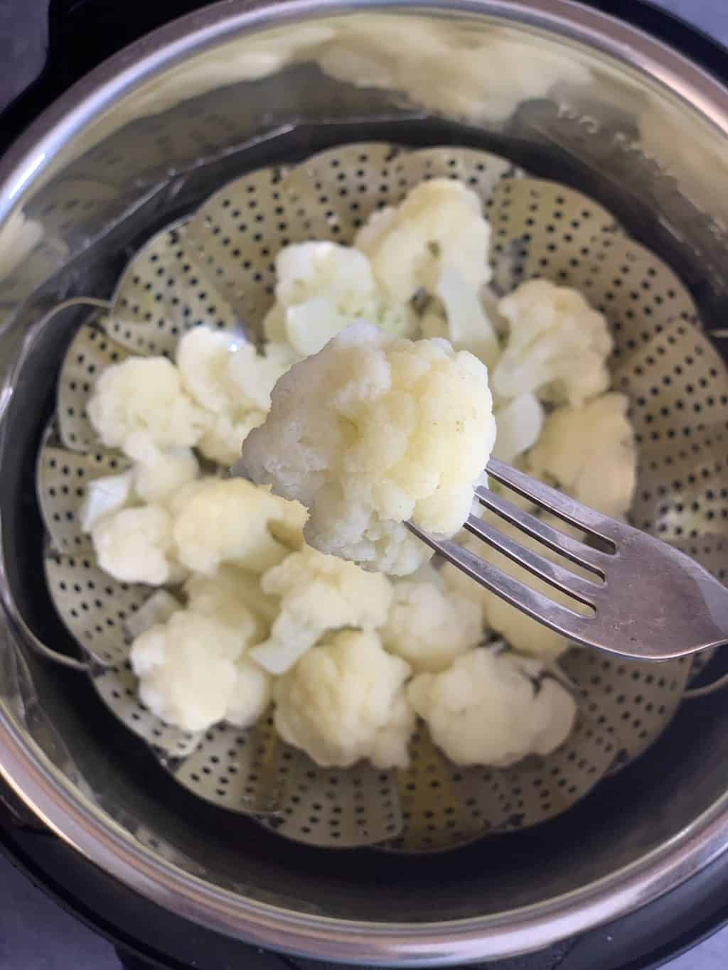 steamed cauliflower in a fork