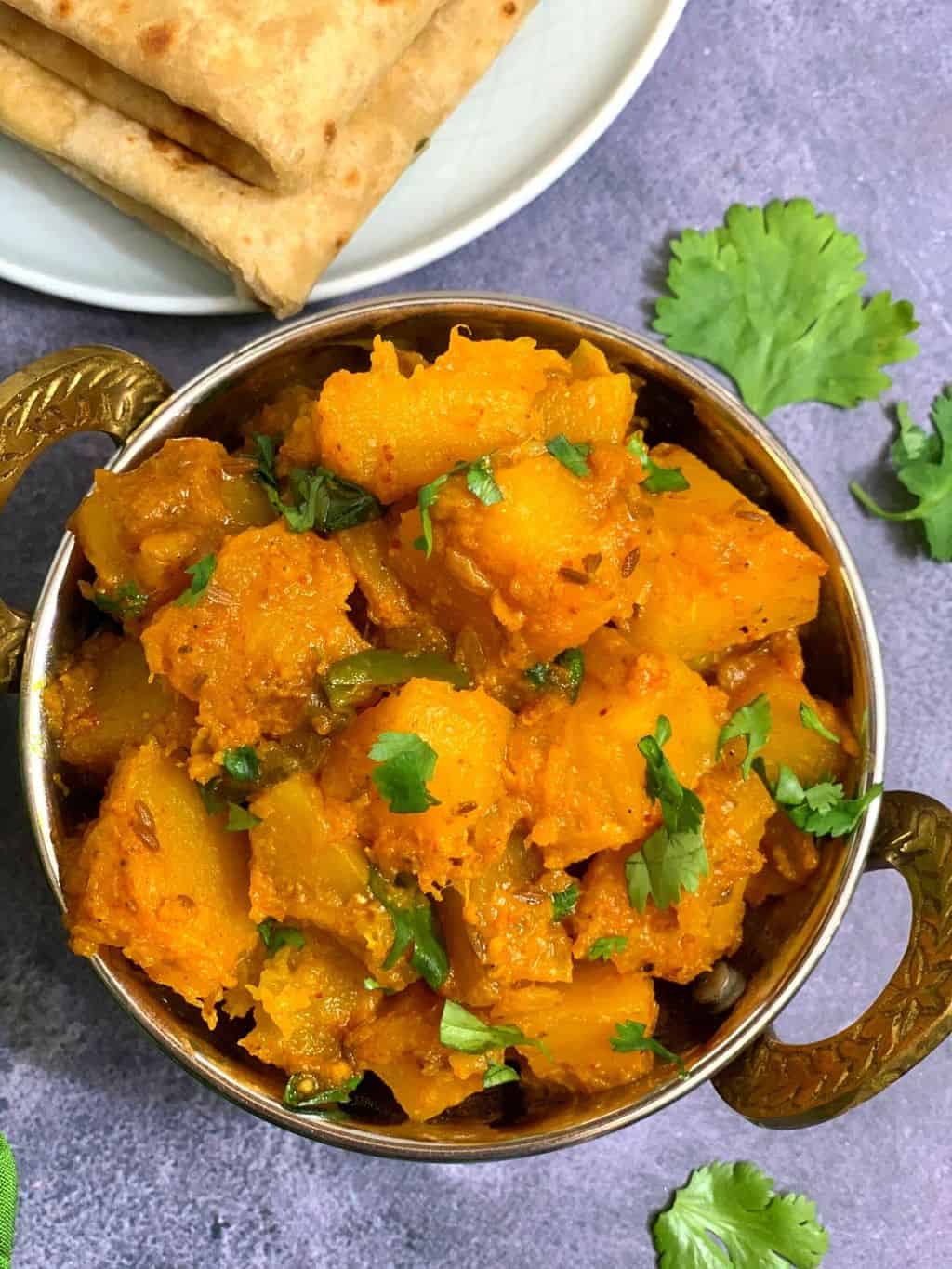 Yellow Pumpkin Masala Curry in a bowl made in the Instant Pot pressure cooker and served with Chapati