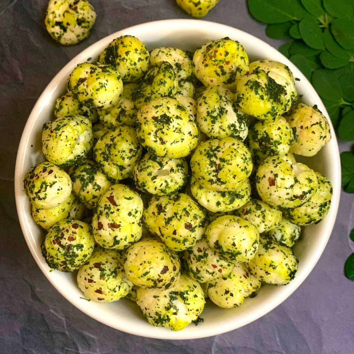 moringa makhana served in a bowl with moringa leaves on side