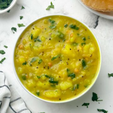 potato sagu served in a bowl with poori on the side