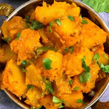 Pumpkin Masala curry served in a kadai with side of chapati