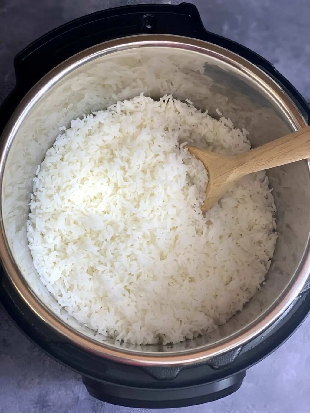 perfectly cooked rice with a wooden spoon