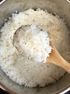 hot steamed sona masuri rice in a wooden laddle