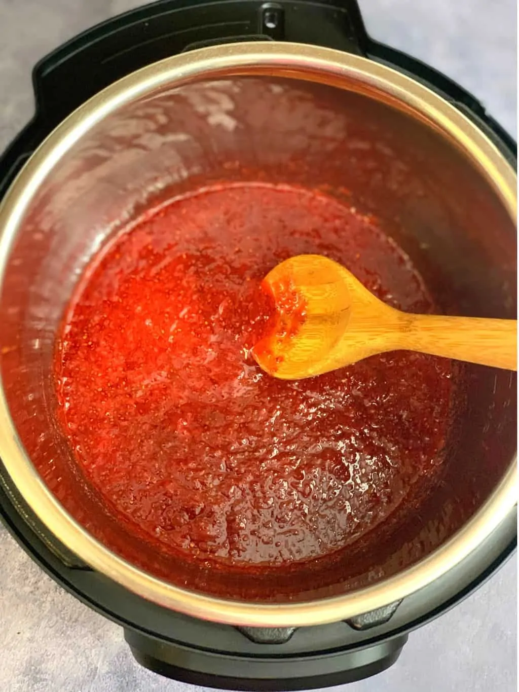 jam in instant pot insert with a spoon