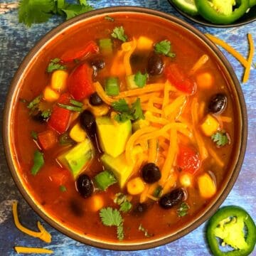 Vegetarian Taco Soup served in a bowl topped with cheese beans and avocado