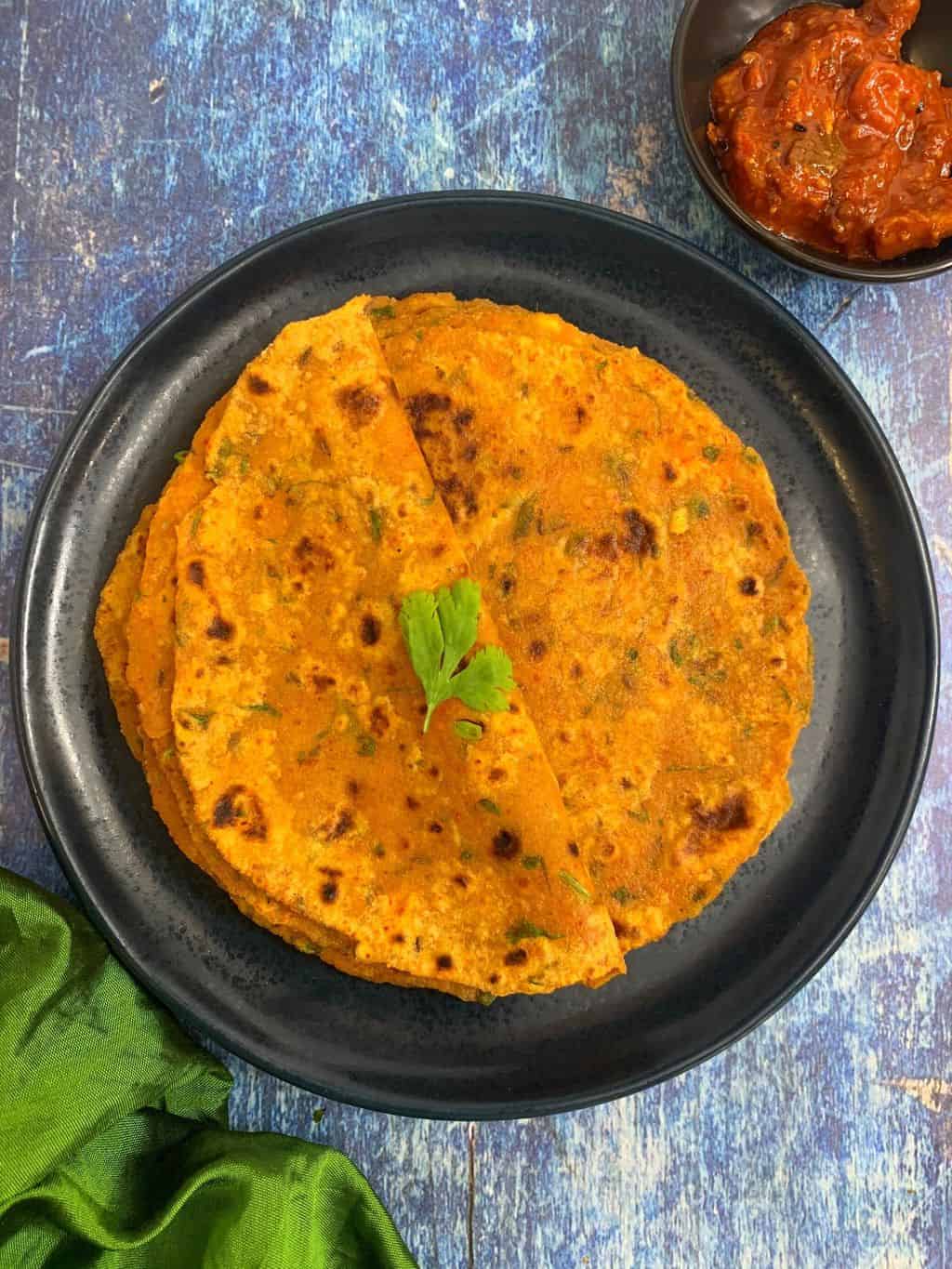 tofu paratha served in a plate with side of pickle