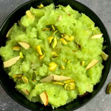 Bottle Gourd Halwa served in a bowl with pistachios and almonds on top