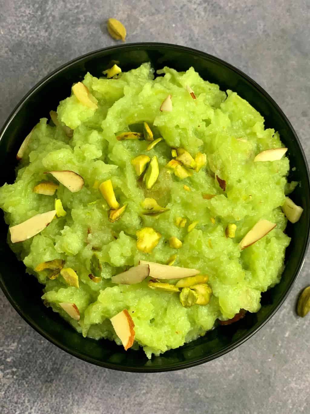 Bottle Gourd Halwa or Lauki ka halwa served in a black bowl topped with nuts made in instant pot pressure cooker