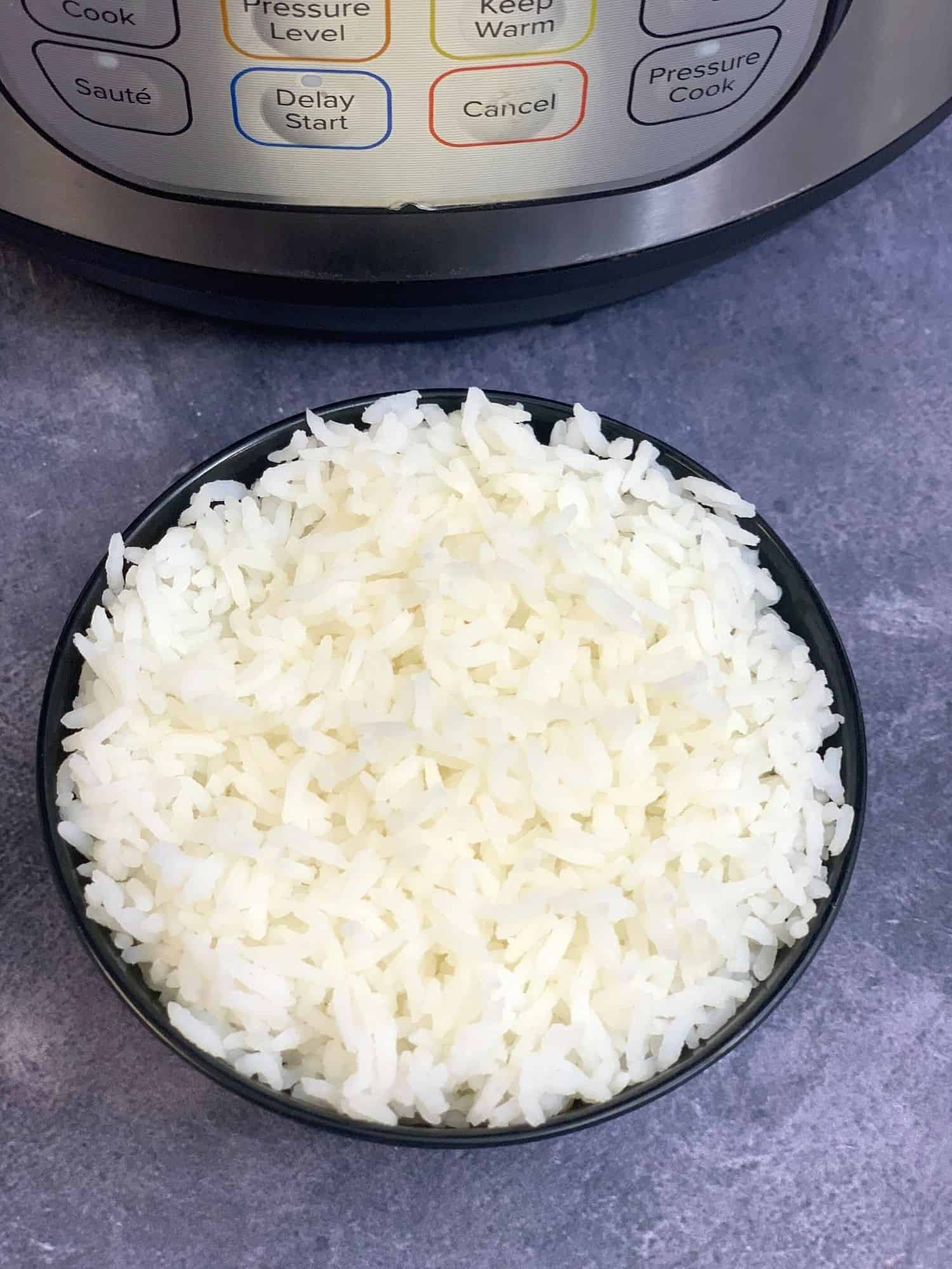 sona masoori rice served in a bowl with instant pot on the other side