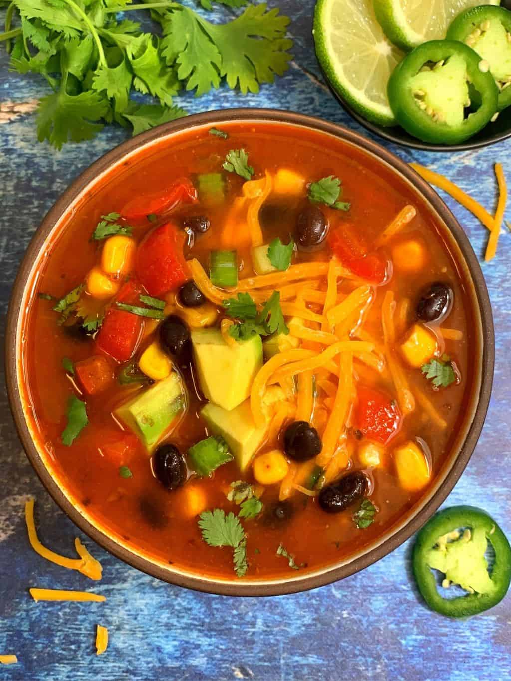 instant pot taco soup served in a bowl and lemon wedges on side