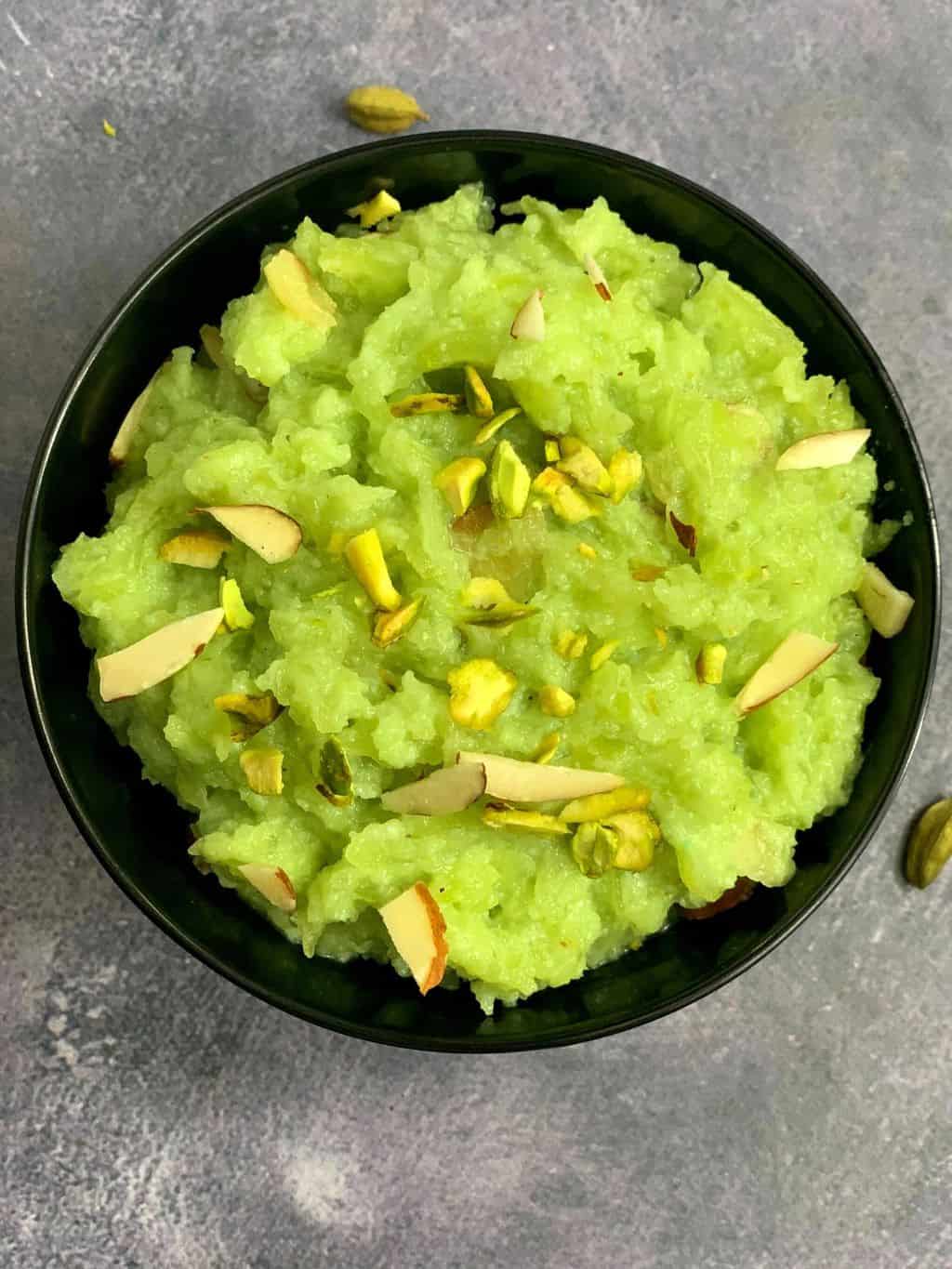 instant pot pressure cooker bottle gourd halwa served in a bowl garnished with nuts