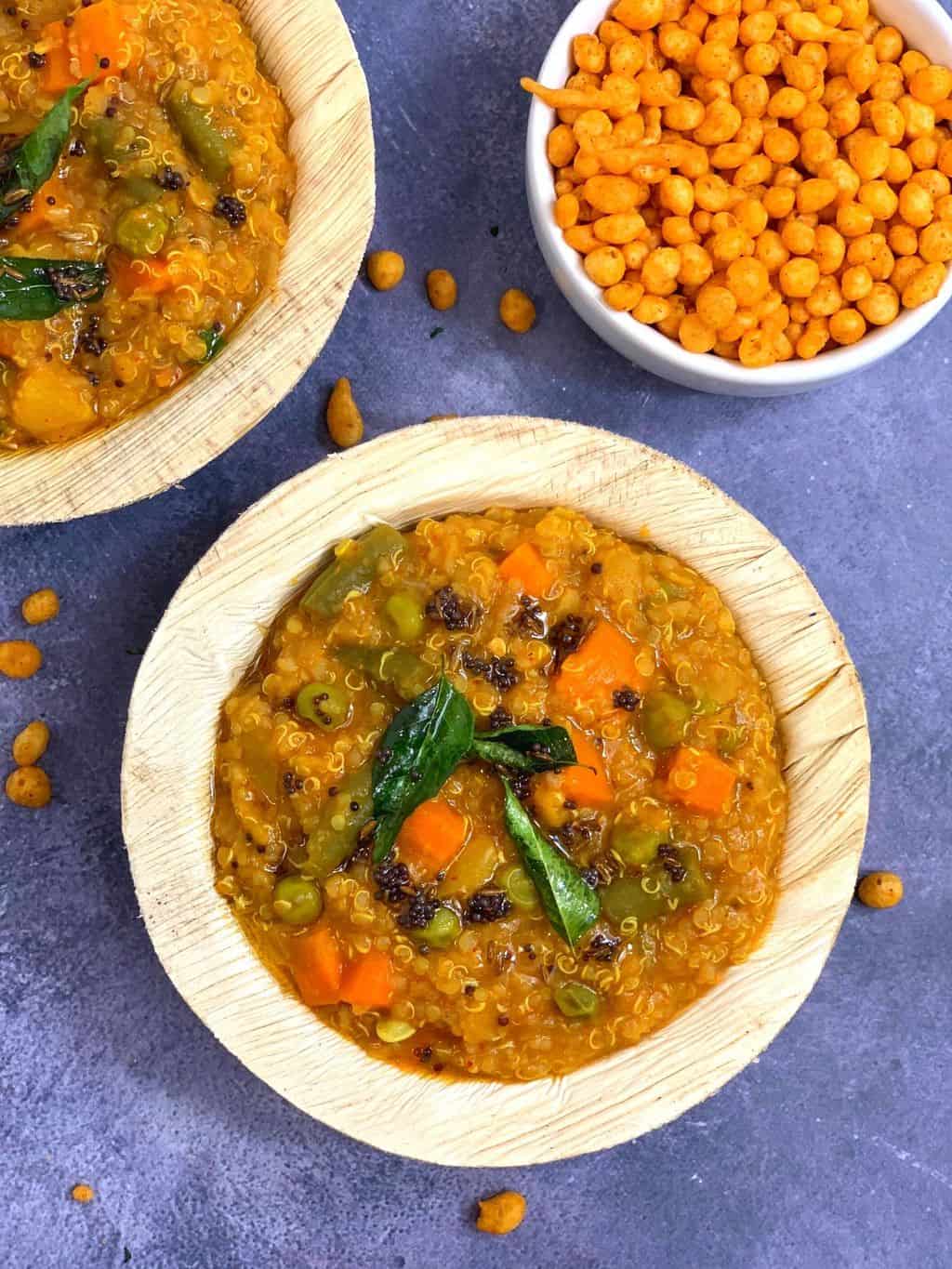 Quinoa Bisibelebath Recipe served in a bamboo serving bowl with boondi on the side