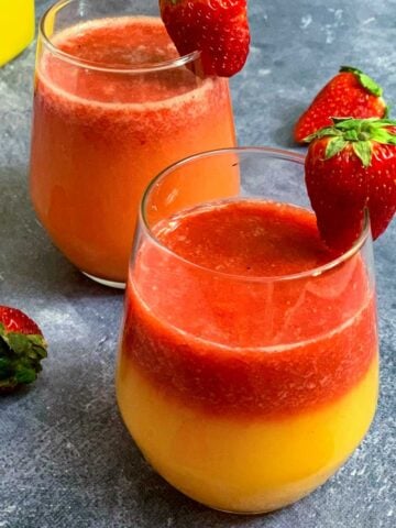 Strawberry Orange juice served in 2 glasses with strawberry on top