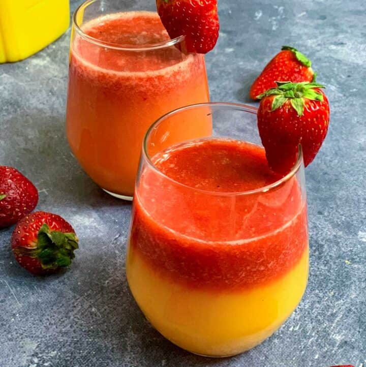 Strawberry Orange juice served in 2 glasses with strawberry on top