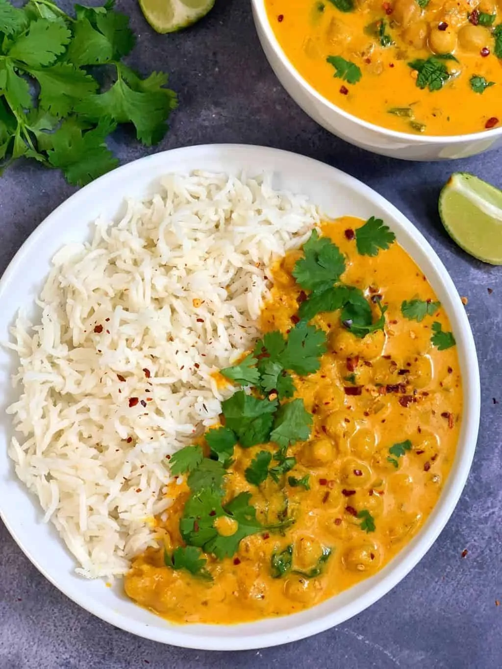 vegan chickpeas curry with white basmati rice on a white plate