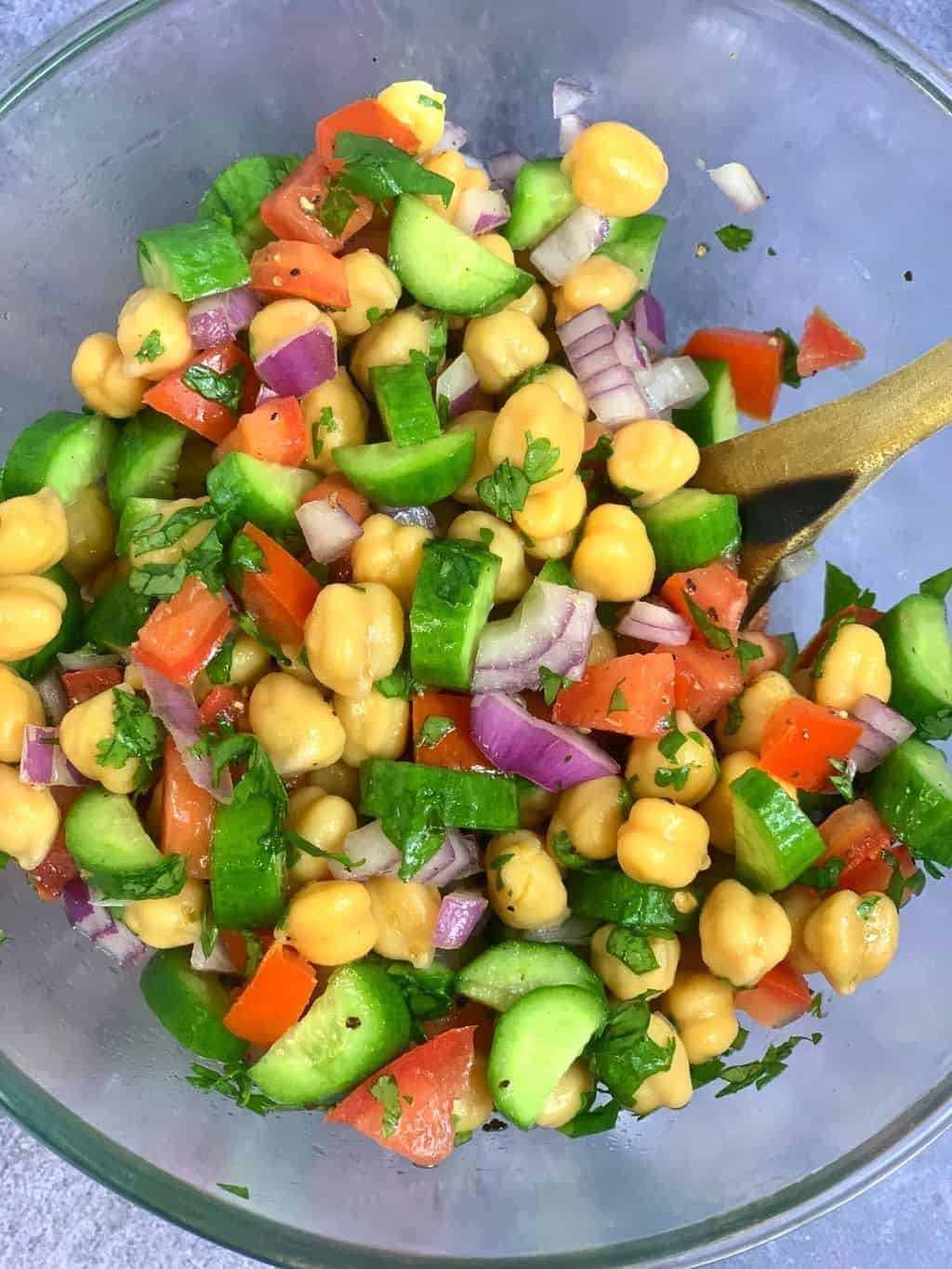 beans and veggies served in a bowl with wooden spoon