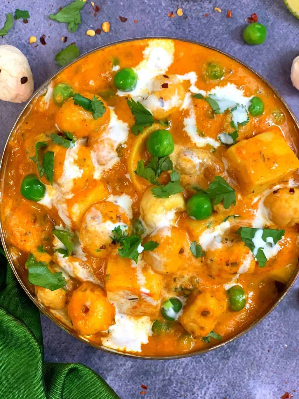paneer makhana curry served in a bowl garnished with cream and coriander leaves.