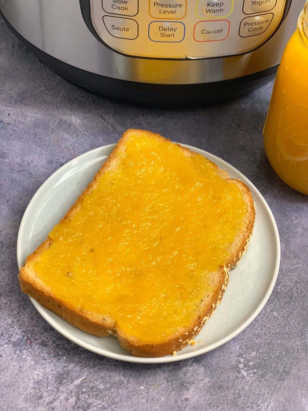 pineapple jam spread on a bread and served on a plate