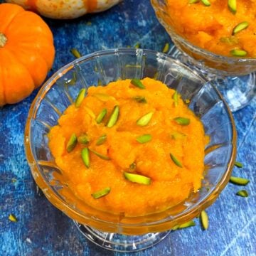 Pumpkin Halwa served in a glass bowl with pistachios on top