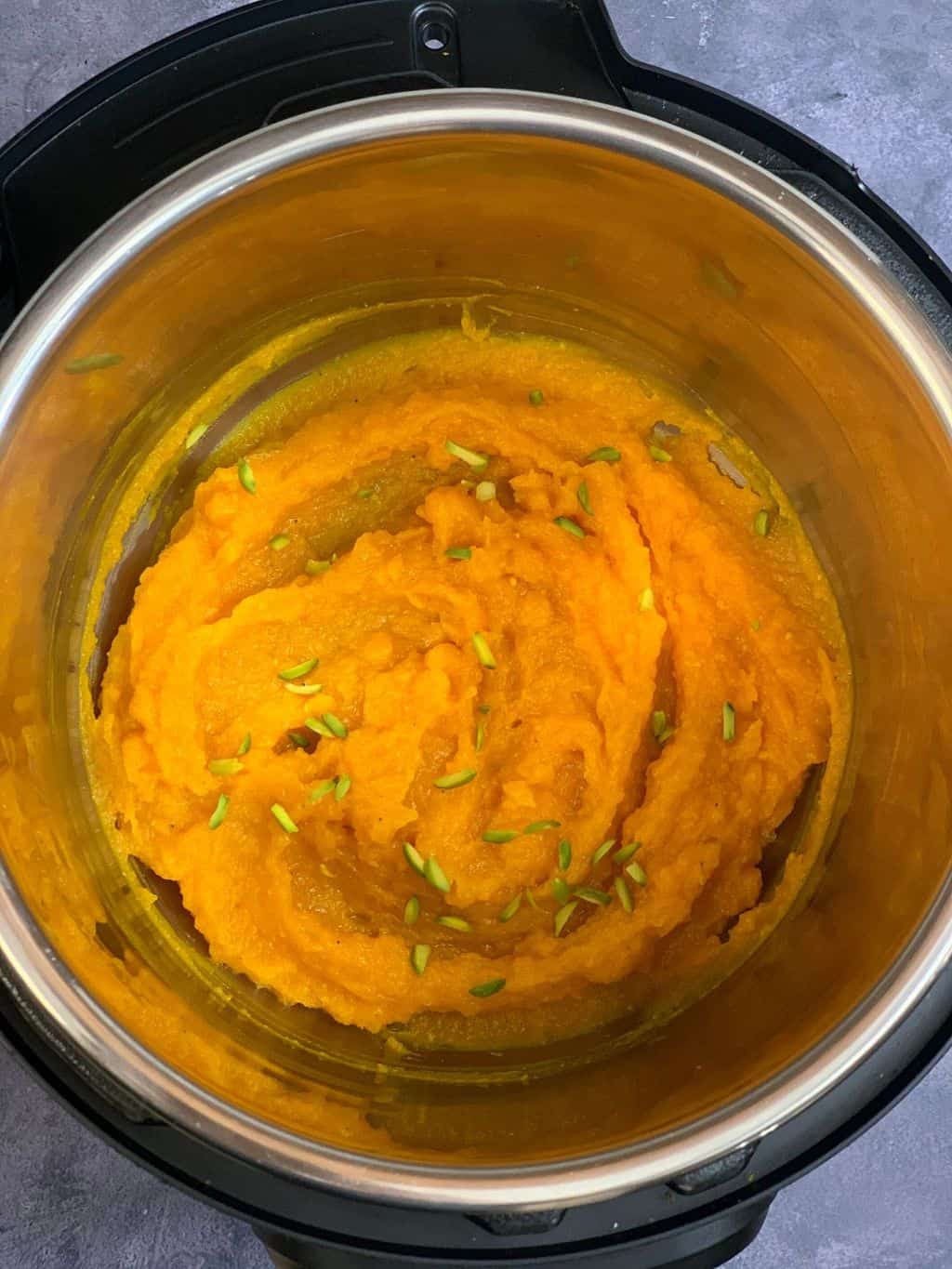 pumpkin halwa or kaddu ka halwa in instant pot insert garnished with nuts
