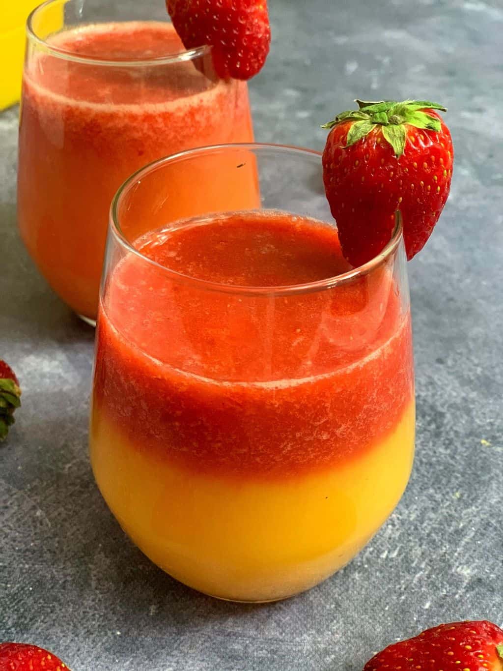 Strawberry and Orange juice served in a glass with fresh strawberry for garnish