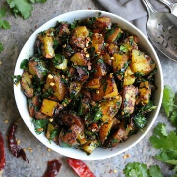 Moringa Leaves Potato Salad with a spoon on the side