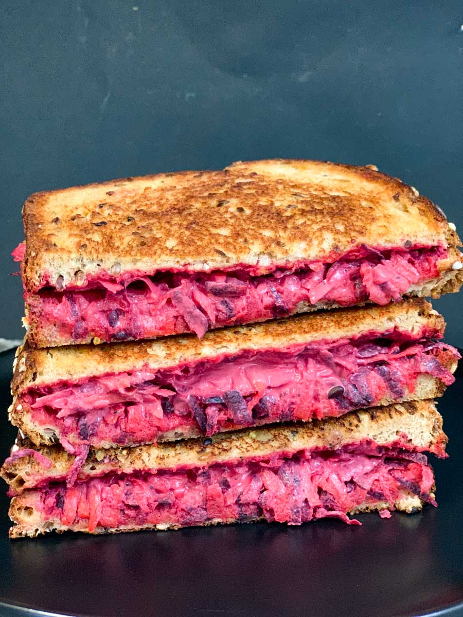 a stack of grilled beetroot carrot sandwich on a plate