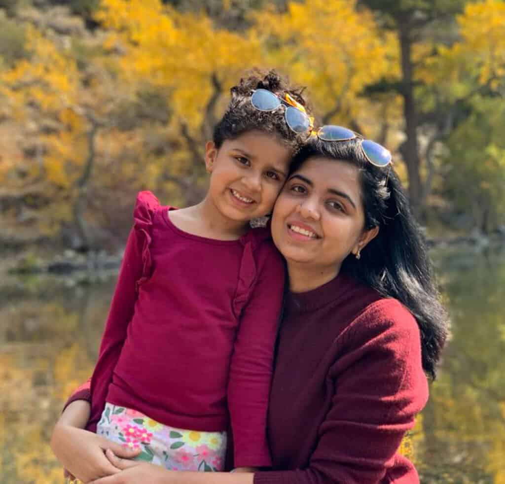 bhavana and dhwani picture with fall tress colors behind