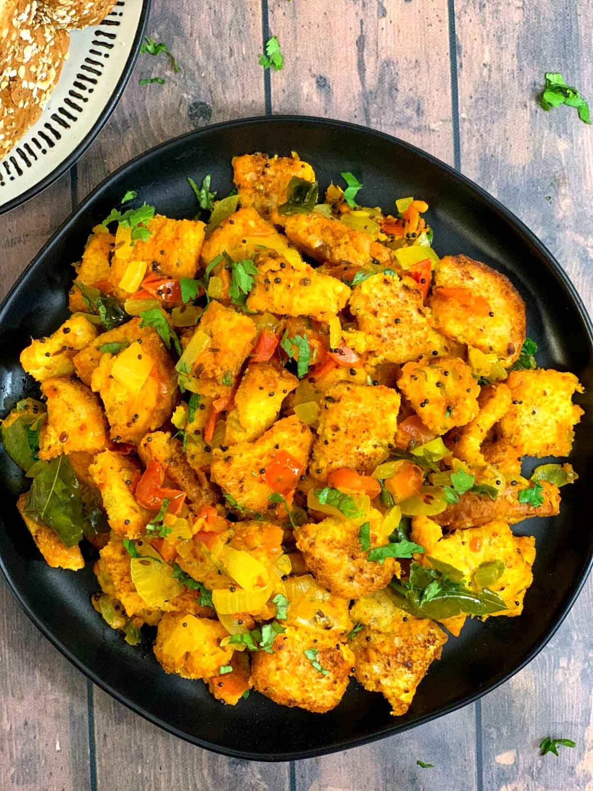 Bread Upma served in a plate garnished with coriander leaves