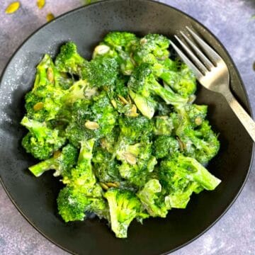 broccoli dill salad served on a plate with a fork
