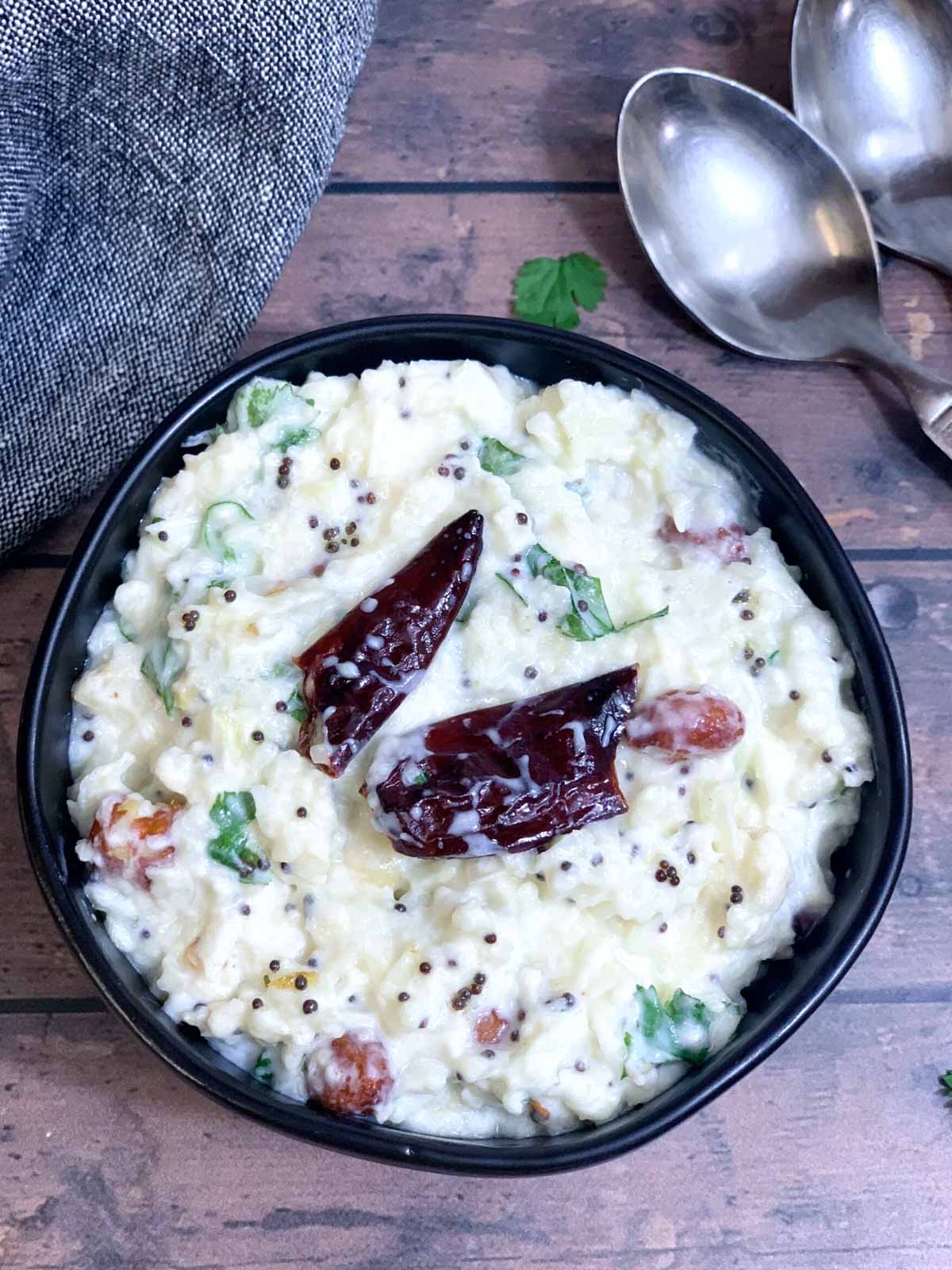 cauliflower curd rice served in a bowl garnished with cilantro