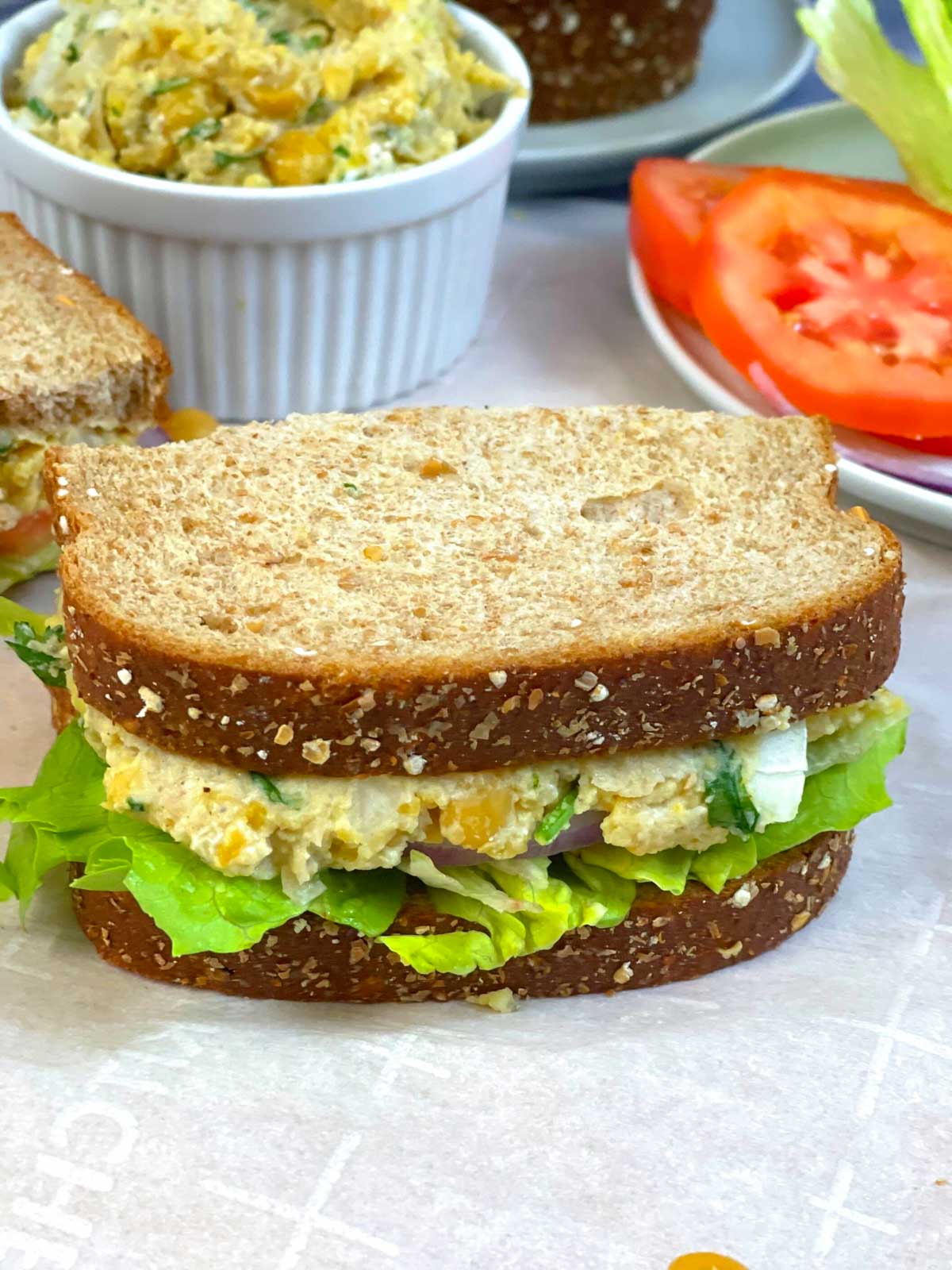 chickpea salad sandwich served with veggies on the side