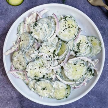 creamy cucumber salad with dill and sour cream served on a plate